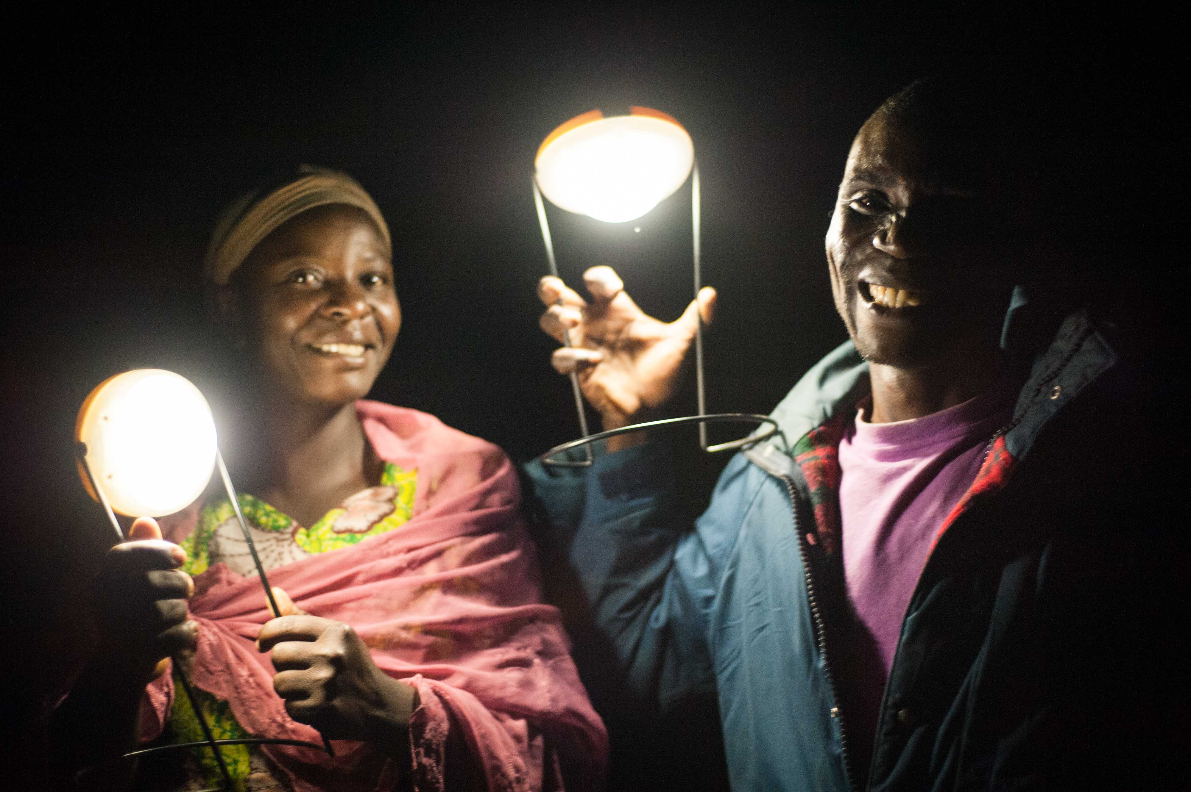 Zipporah and David hold the two solar lights in the darkness. Credit: Hailey Tucker.