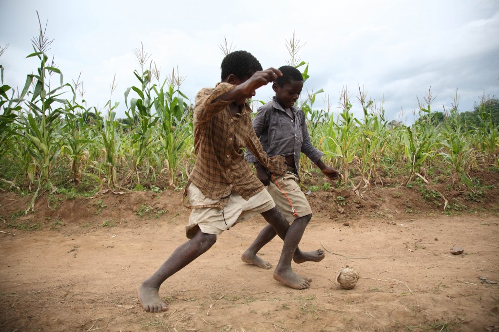 Boys play football in Khulungira, Malawi