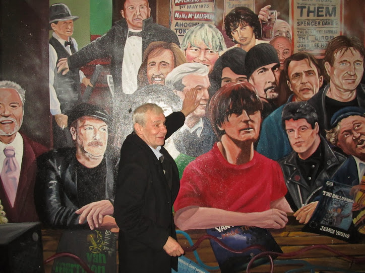 Terri Hooley in front of a mural in the Cathedral quarter, Belfast, last November... 