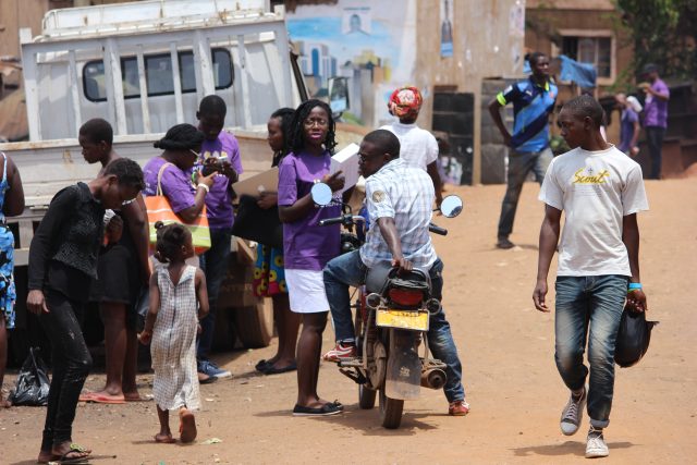 Robinah Distributing condoms to people in Kikubamutwe in Kampala, Uganda.