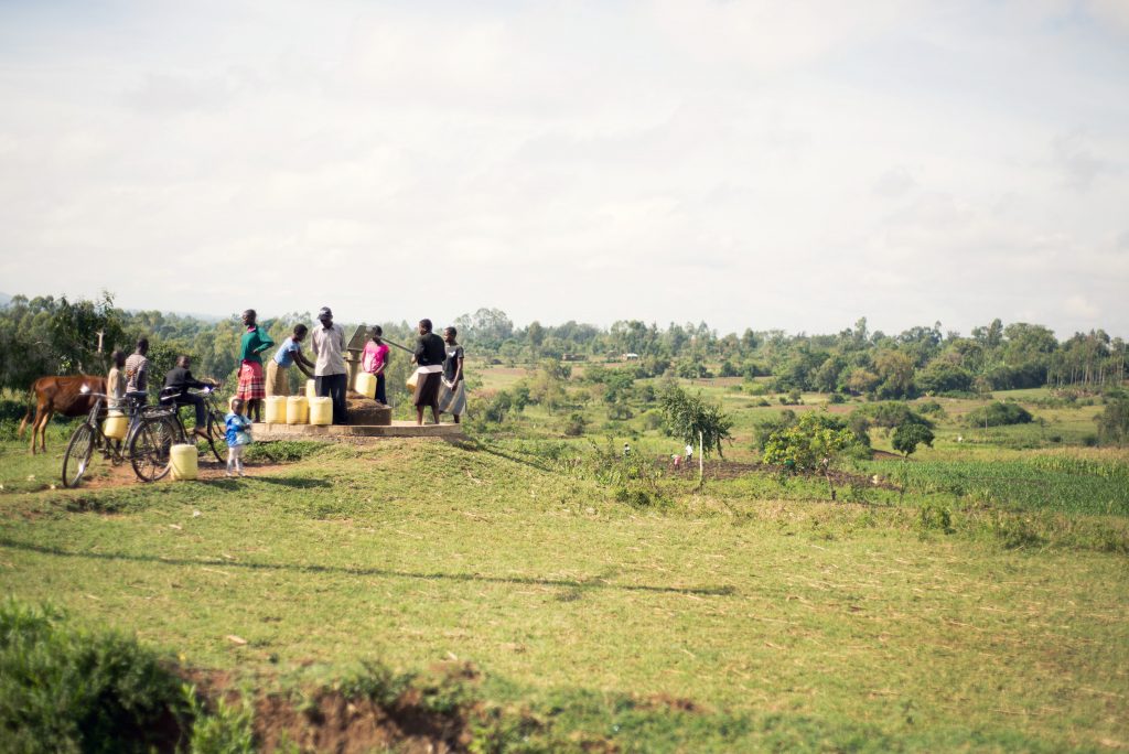 Resident of Luucho gather at a water pump to collect water to take to their homes, most of which do not have running water.