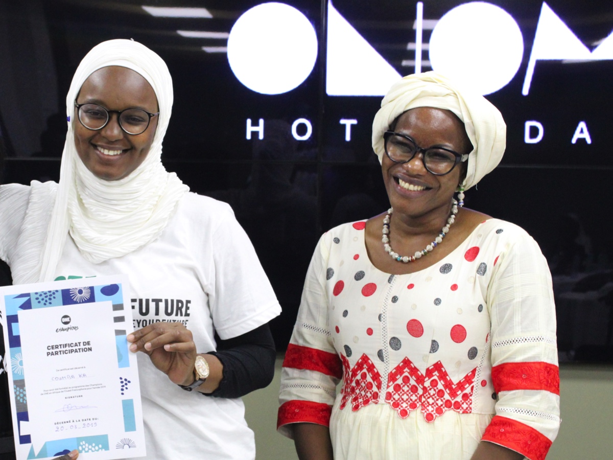 Coumba Ka (left) collects her ONE Champion certificate from Oulie Keita, ONE Director Francophone West Africa (right).