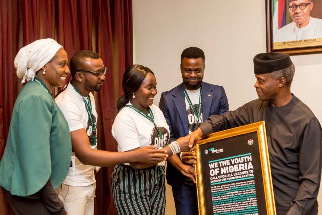 Wadi Ben-Hirki (middle) a ONE member, hands the Youth Declaration to Vice President of Nigeria, Prof. Yemi Osinbajo (right).