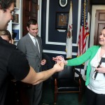Illinois ONE volunteers giving a ONE band to a staff member in a Congressional office