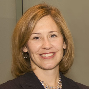 headshot of Michelle Grogg against a brown background
