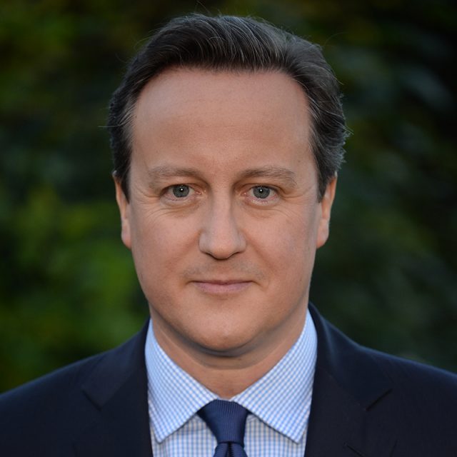headshot of David Cameron against a dark green background