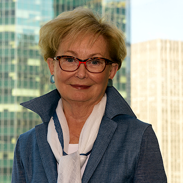 headshot of Diane Whitty with skyscrapers in the background