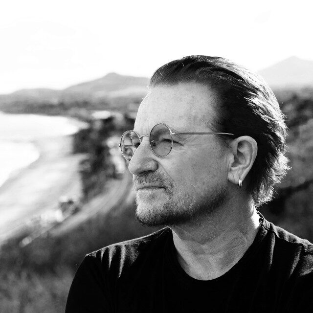 black and white headshot of Bono looking to the distance