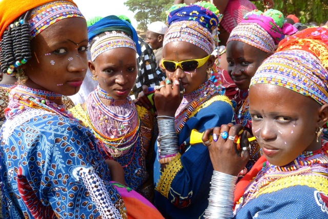 Fulani girls dressed in their "day-glo" best young Fulani girls all dressed up for the big social festival rather than wearing only traditional materials, these girls are embracing modern colors and materials like nail polish. Gaani Festival in the town of Nikki, Benin honoring their King in 2013