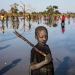 Yacob Ibrahim, a 10-year-old refugee from the Nuba Mountains in Sudan, fishes in a lake near Yida, South Sudan. Yacob's family fled Sudan three years ago and now live in Yida with thousands of other refugees. Like most of the children fishing here, he uses a stick to strike the fish when they surface.

