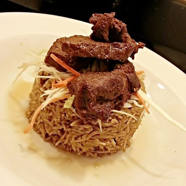 A traditional African Arabic spiced rice known as Pilau, topped with pan-fried beef strips and shredded cabbages with carrots. (Photo credit: Jordan808/Wikimedia Commons)