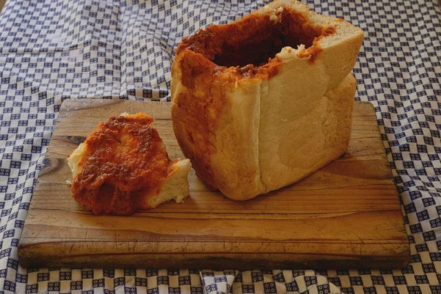 A carbo loaded fast food beloved by South Africans, Bunny Chow consists of a hollowed-out half-loaf of white bread filled with a variety of curries. (Photo credit: Lucinda jolly/Wikimedia Commons)